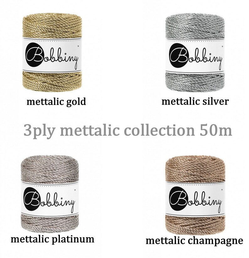 May include: Four spools of 3-ply metallic yarn in gold, silver, platinum, and champagne colors. Each spool is labeled "Bobbiny" and is 50 meters long.