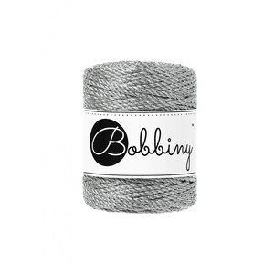 May include: A spool of silver metallic twine with a white label that says "Bobbiny" in black cursive lettering.
