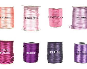 May include: Spools of satin cord in various shades of pink and purple, including Salmon, Light Pink, Candy Pink, Orchid, Pink Bordo, Bishop, Plum, and Light Heather.