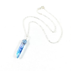May include: A silver chain necklace with a blue crystal pendant. The crystal is wrapped in silver wire.