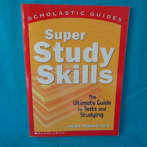 May include: A red and yellow book titled "Super Study Skills: The Ultimate Guide to Tests and Studying" by Laurie Rozakis, Ph.D.  The book is part of the Scholastic Guides series.