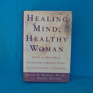 May include: A hardcover book titled Healing Mind, Healthy Woman: Using the Mind-Body Connection to Manage Stress and Take Control of Your Life by Alice D. Domar, Ph.D., and Henry Dreher. The cover features dark purple text on a cream background.