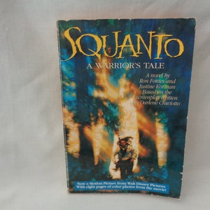 May include: Book cover for "Squanto: A Warrior's Tale" by Ron Fontes and Justine Korman. The cover features a blurred image of a man in a forest setting. The book is based on the screenplay written by Darlene Craviotto.