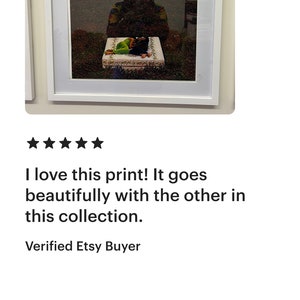 May include: A framed print featuring a black and white photograph of a person lying on a bed with the text "YOU DESERVE A BREAK TODAY." printed in white.