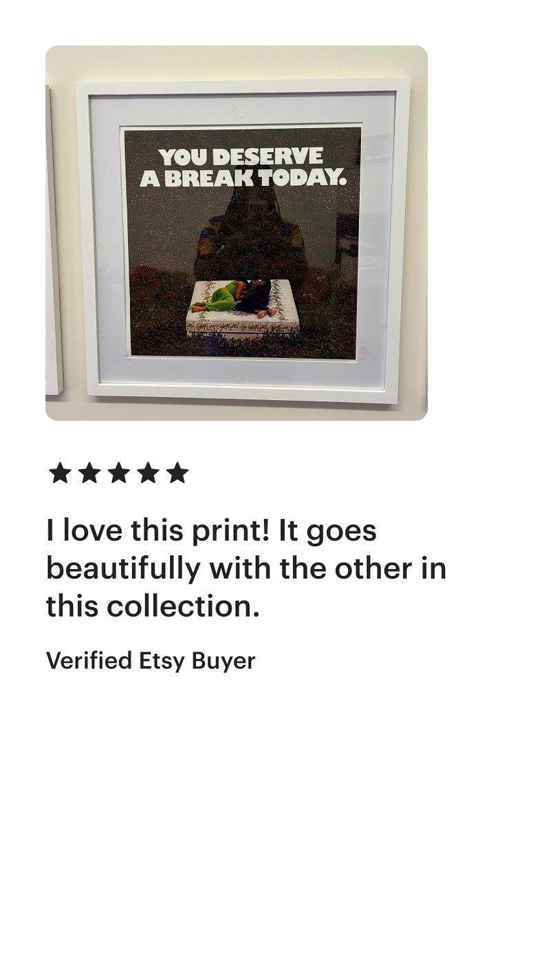 May include: A framed print featuring a black and white photograph of a person lying on a bed with the text "YOU DESERVE A BREAK TODAY." printed in white.