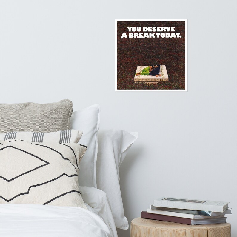May include: A white square with black text that reads "YOU DESERVE A BREAK TODAY."  A person is lying on a white mattress in a grassy area.