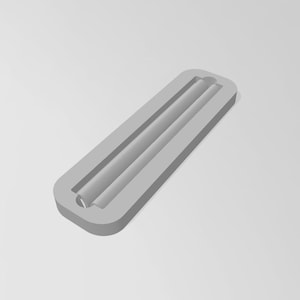 May include: A light grey rectangular silicone mould featuring a long, narrow, cylindrical cavity running through the centre. The mould has rounded corners and a smooth, matte finish, designed for casting elongated shapes with a uniform appearance.