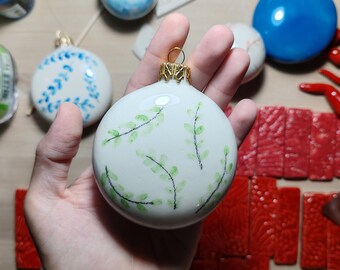 Ceramic Christmas bauble. Green sprig