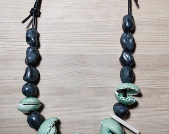Ceramic necklace. Green and metallic ears