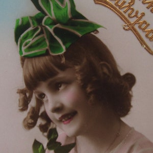 Old postcard of a little girl with a lovely hair bow, antique postcard, vintage postcard children