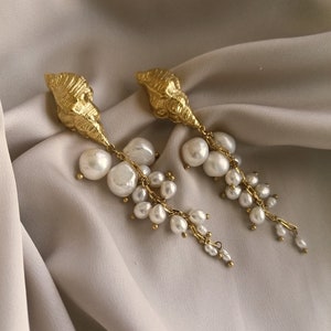 Beautiful dangling earrings with a cascade of pearls and a vintage shell, bathed in gold or silver, made by hand in Paris, France