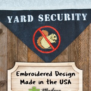 May include: Black and white embroidered patch with the text "YARD SECURITY" and a red circle with a diagonal line through it, depicting a squirrel. The patch is on a wooden background with a sign that reads "Embroidered Design Made in the USA" and a logo for Mydye.