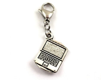May include: A silver laptop charm with a silver chain and a lobster clasp. The laptop charm is detailed with a screen, keyboard, and touchpad.