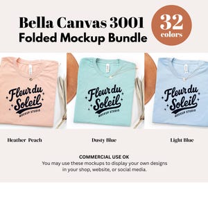 May include: Three Bella Canvas 3001 folded mockup t-shirts in Heather Peach, Dusty Blue, and Light Blue. Each shirt features the "Fleur du Soleil" logo. The image also includes a color wheel with "32 colors" and text that reads "Commercial Use OK."
