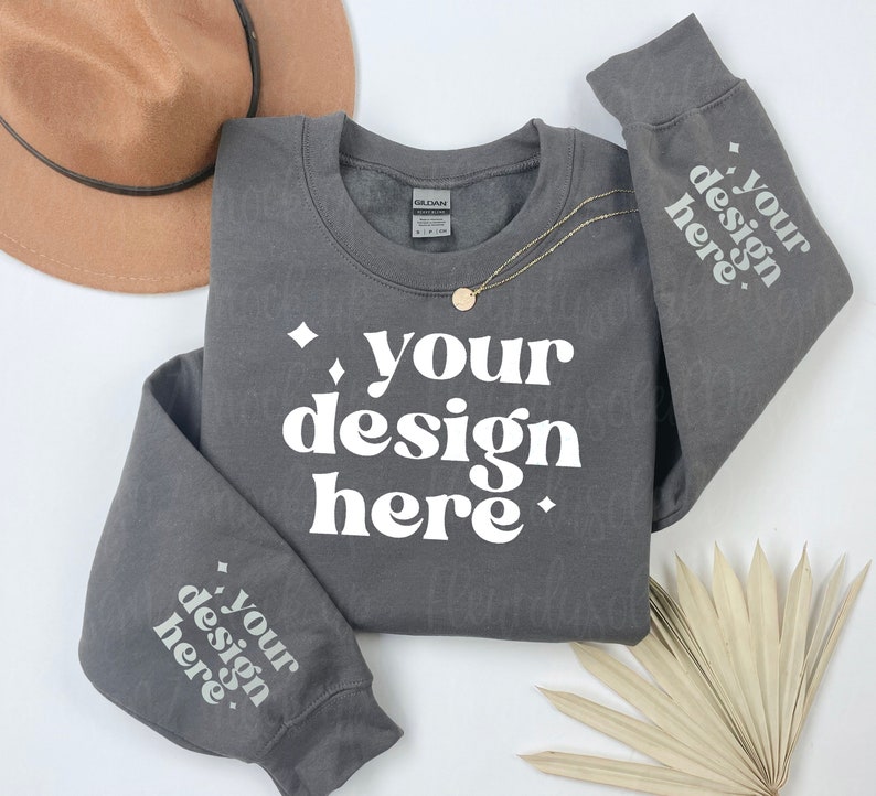 May include: A charcoal grey sweatshirt with the text "your design here" printed in white on the front and both sleeves.