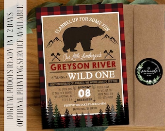 May include: A rustic brown and red plaid invitation with a cartoon bear and the text "Flannel Up For Some Fun" and "Our Little Lumberjack Greyson River is Turning a Wild One". The invitation is for a birthday party on December 8th and includes the text "Hike on Over to Celebrate. We Wood Love to See You".