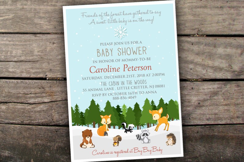 May include: A blue and white baby shower invitation with a winter woodland theme. The invitation features a snowflake, pine trees, and woodland animals like a fox, deer, raccoon, squirrel, and hedgehog. The text reads "Friends of the forest have gathered to say A sweet little baby is on the way! Please join us for a baby shower in honor of mommy-to-be Caroline Peterson Saturday, December 21st, 2018 at 2:00pm The Cabin in the Woods 55 Animal Lane, Little Critter, NJ 08081 RSVP by October 16th to Anna 888-856-4049 Caroline is registered at Buy Buy Baby"