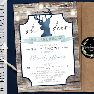 May include: A blue and white baby shower invitation with a watercolor deer illustration and the text "oh deer, a little buck is almost here". The invitation includes details for the event, including the date, time, location, and RSVP information.