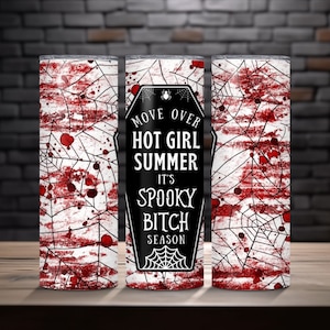 May include: Three tall, cylindrical tumblers with a spooky theme. The design features a white spiderweb pattern with red blood splatters. The center tumbler has a black coffin shape with the text "MOVE OVER HOT GIRL SUMMER IT'S SPOOKY BITCH SEASON."
