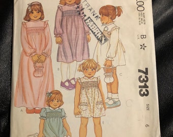 May include: McCall's sewing pattern number 7313 size 6 for a girl's dress. The pattern includes five different dress styles with various necklines, sleeves, and embellishments. The pattern is printed on a white background with black text and illustrations.