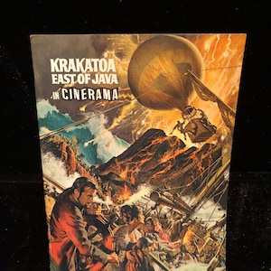 May include: A vintage movie poster for "Krakatoa, East of Java" in Cinerama. The artwork depicts a dramatic scene of a volcanic eruption, a hot air balloon, and a ship in distress. The poster features a man in a red coat and a distressed crowd.