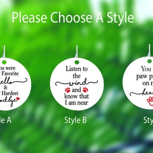 May include: Three white, round ornaments with black and red text. Each ornament has a different phrase about pets. The text includes "You were My Favorite hello & My Hardest goodbye", "Listen to the wind and know that I am near", and "You left paw prints on my heart".