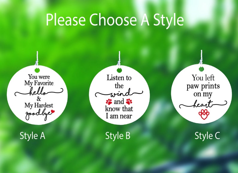 May include: Three white, round ornaments with black and red text. Each ornament has a different phrase about pets. The text includes "You were My Favorite hello & My Hardest goodbye", "Listen to the wind and know that I am near", and "You left paw prints on my heart".