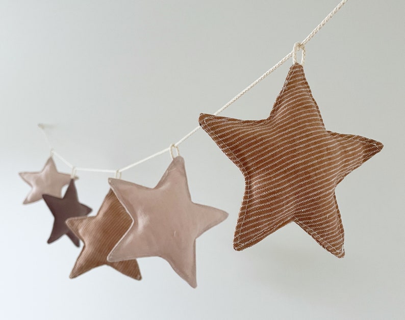 stuffed fabric stars hanging on a rope