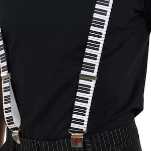 May include: Black and white striped pants with a black shirt and piano key suspenders.