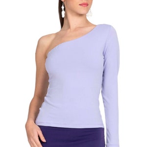May include: A light purple one-shoulder top with a long sleeve. The top is paired with a dark purple skirt. The outfit is form-fitting and appears to be made of a stretchy material. The model is wearing dangling earrings.