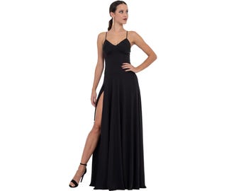 May include: A black maxi dress with a V-neckline and spaghetti straps. The dress has a high slit on the left side and a flowing skirt.