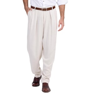 May include: A pair of beige pleated pants with a brown leather belt.
