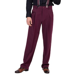 May include: Deep burgundy trousers featuring a high-waisted design with double front pleats, a button closure, and belt loops. The pants have a straight-leg cut and are paired with patterned suspenders attached to the waistband over a black shirt.