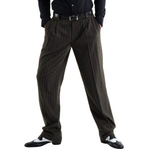 May include: A pair of black pinstriped pants with a black belt. The pants have a pleated front and are worn with black and white shoes.