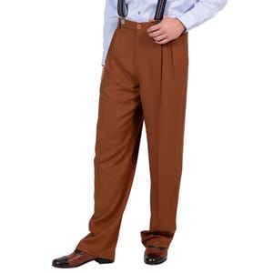 May include: High-waisted trousers in a solid brown color featuring a pleated front, a button closure at the waistband, and a straight-leg cut. The trousers are paired with dark blue and orange striped suspenders and brown leather dress shoes.