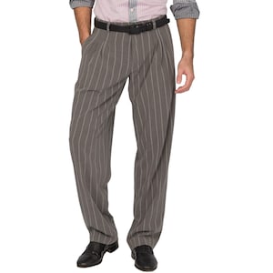 May include: Gray pinstripe trousers with a pleated front and a black belt. The trousers have a relaxed fit and are paired with black dress shoes. The vertical stripes create a slimming effect. The model is wearing a striped shirt.
