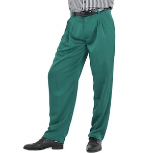 May include: A pair of emerald green dress pants with pleats. The pants have a black belt and are made of a smooth fabric.