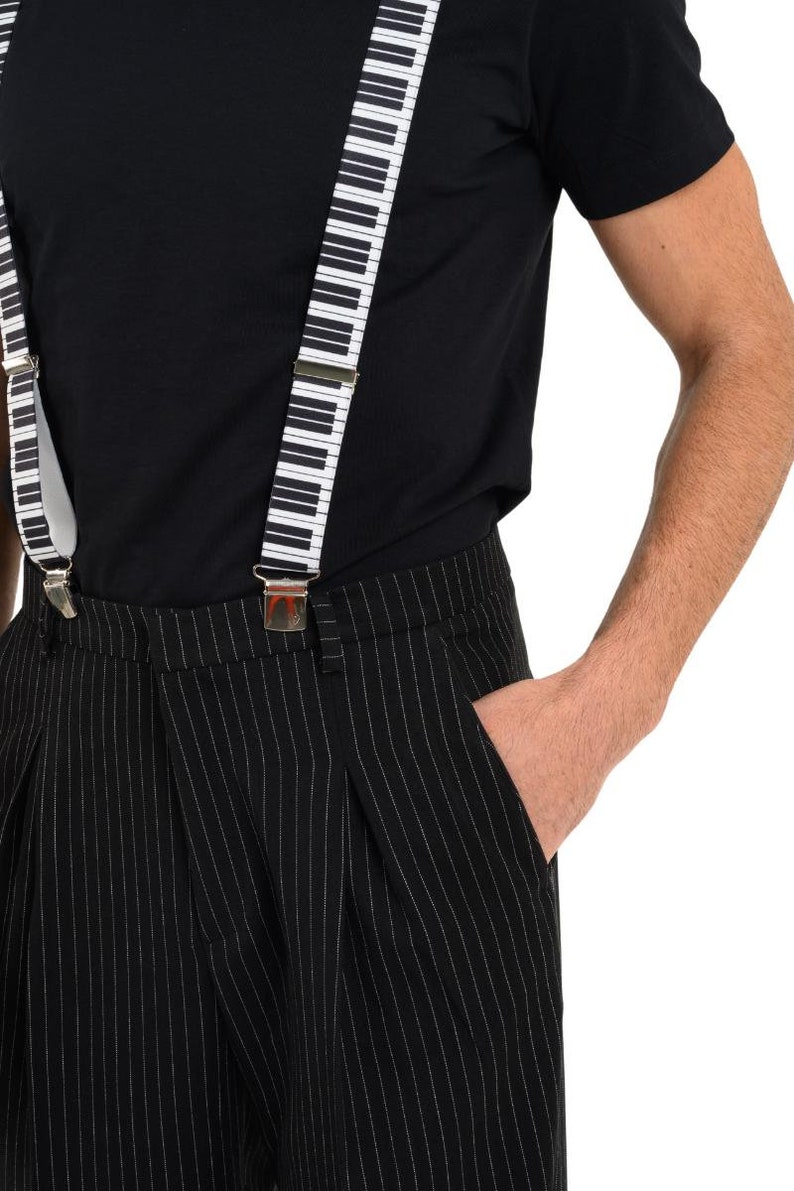 May include: Black and white striped pants with a black shirt and piano key suspenders.