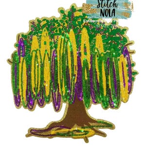 May include: A sequined tree design in gold, green, and purple, with a brown trunk and gold accents. The image includes the text "Stitch NOLA" and "EMBROIDERY SINCE 2014". The design is likely for embroidery or applique.