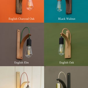 May include: Six wall-mounted light fixtures with different wood finishes and cord colours. The wood finishes include English Charcoal Oak, Black Walnut, English Elm, English Oak, English Ash, and Black English Oak. Each fixture has a single light bulb.