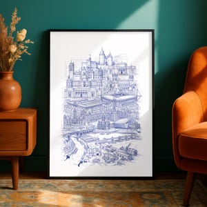 May include: A framed vertical art print featuring a detailed blue ink architectural sketch of a city skyline. The illustration depicts various buildings, a stadium, a bridge, and industrial structures with visible construction lines and technical drafting details.