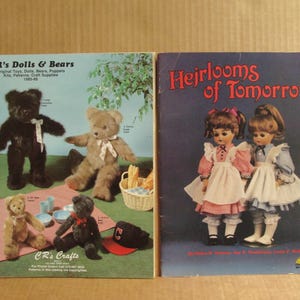 May include: Two vintage craft catalogs titled CR's Dolls & Bears and Heirlooms of Tomorrow. The first features four teddy bears on a picnic blanket. The second displays two dolls in dresses with white aprons against a dark blue background.