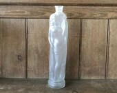 Translucent glass bottle with woman holding an amphora