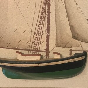May include: A close-up of a wooden model ship with a black and green hull, white trim, and a brown mast. The ship is set against a beige background with a faint drawing of a sailboat.
