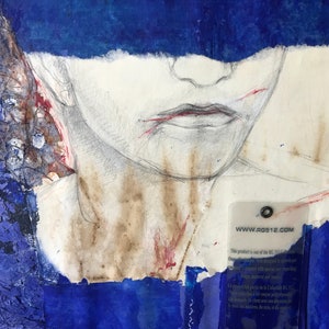 May include: A close-up of a mixed media artwork featuring a pencil drawing of a person's face with red and brown accents. The face is partially obscured by a blue piece of paper. A clear plastic tag with the text "www.rgs12.com" is visible in the lower right corner.
