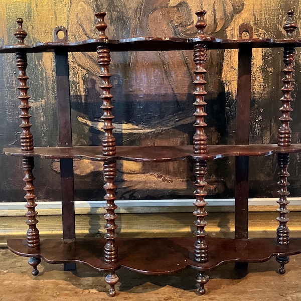 Lightweight fruitwood shelf with columns.