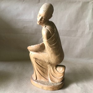 African statuette, kneeling man, with tray in his hands.