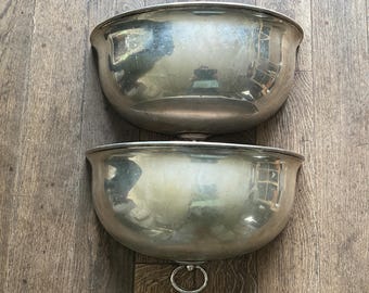 Pair of silver-plated metal planters in the shape of half a bell.
