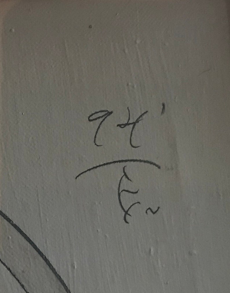 May include: Handwritten signature with the text "94'" above a stylized symbol resembling a stylized "E" with a squiggly line.