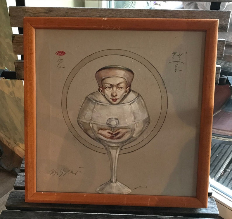 May include: A framed painting depicting a person's head inside a wine glass. The person is wearing a white hat and has a fair complexion. The painting is set against a grey background and features a red circle in the top left corner. The painting is signed in the bottom left corner.